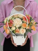 Нежный букет цветов в корзине с розами и хризантемами, подаренный на праздник.